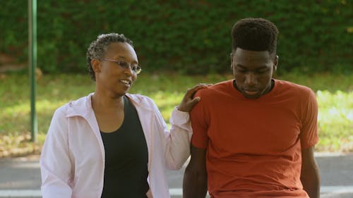 An Elderly Woman Talking to a Man