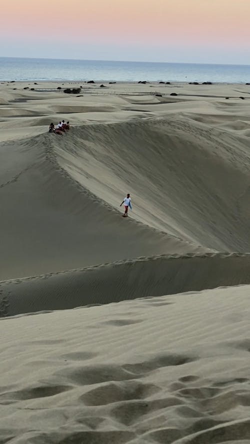 A Man Walking on a Desert