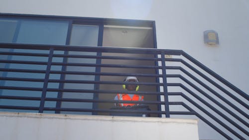 A Female Construction Worker Going Down a Stairway