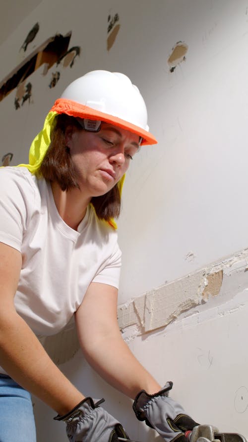A Woman Using a Wrench at a Construction Site