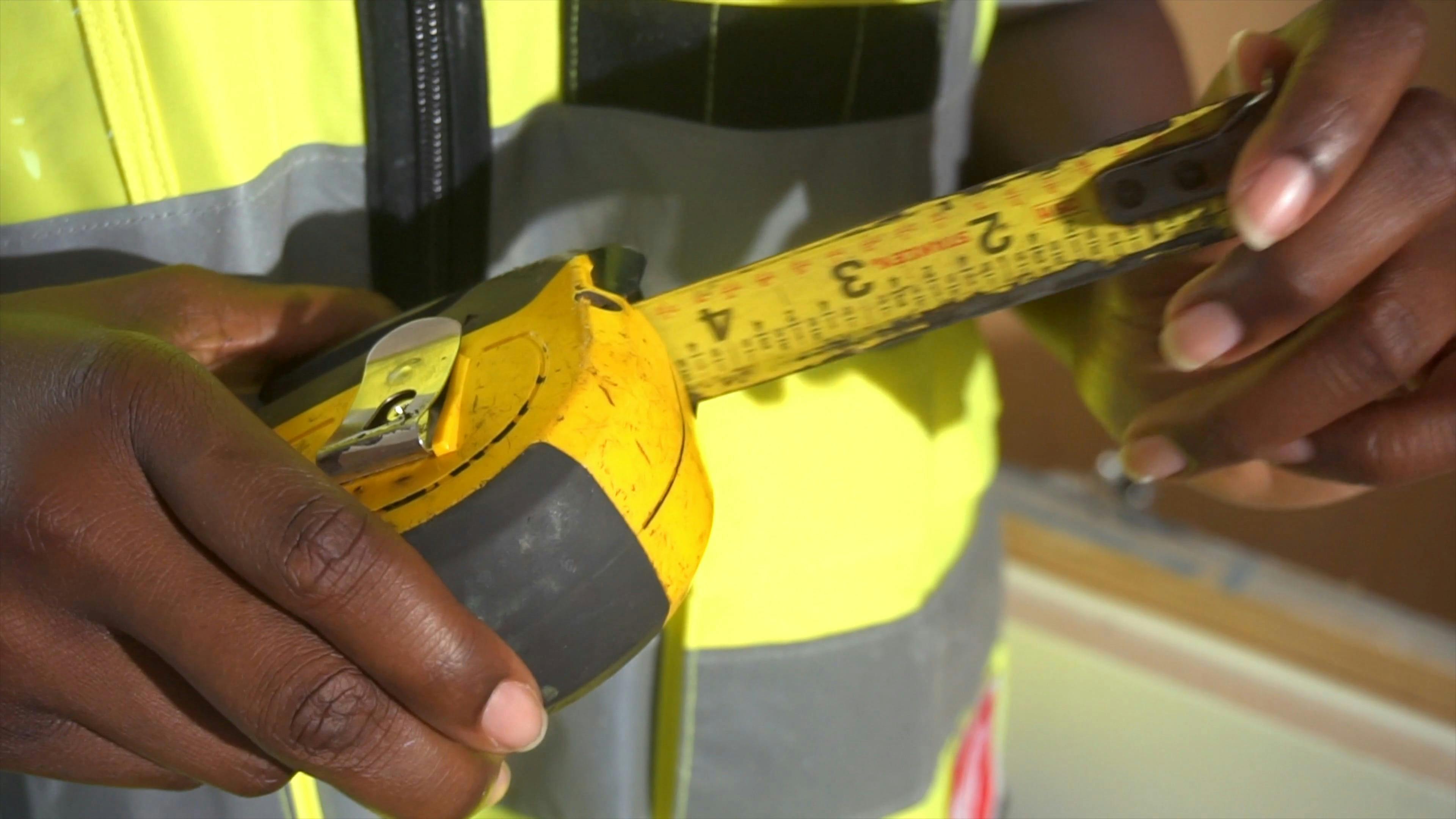 A Woman Holding a Tape Measure Smiling at Camera · Free Stock Video