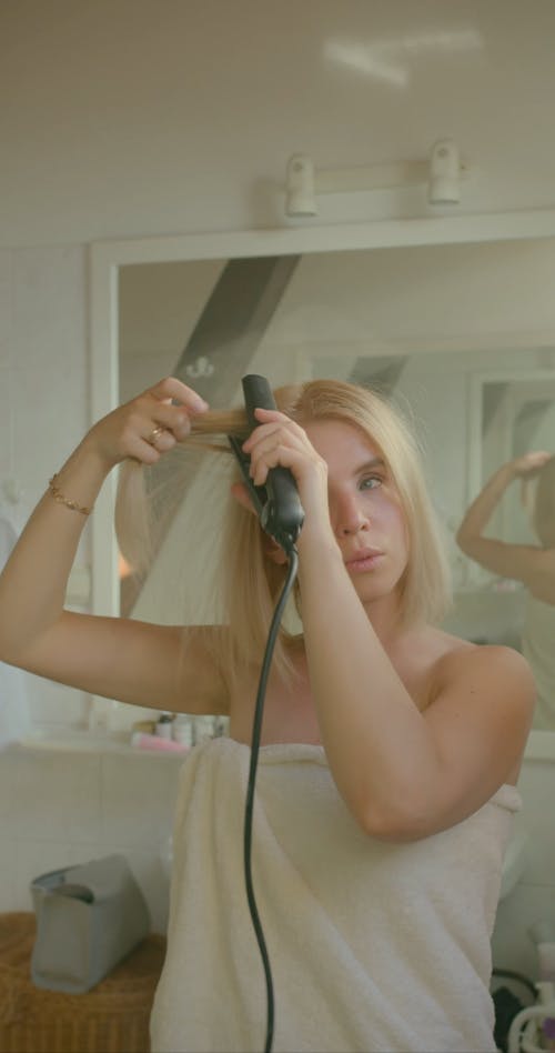 A Woman Straightening Her Hair