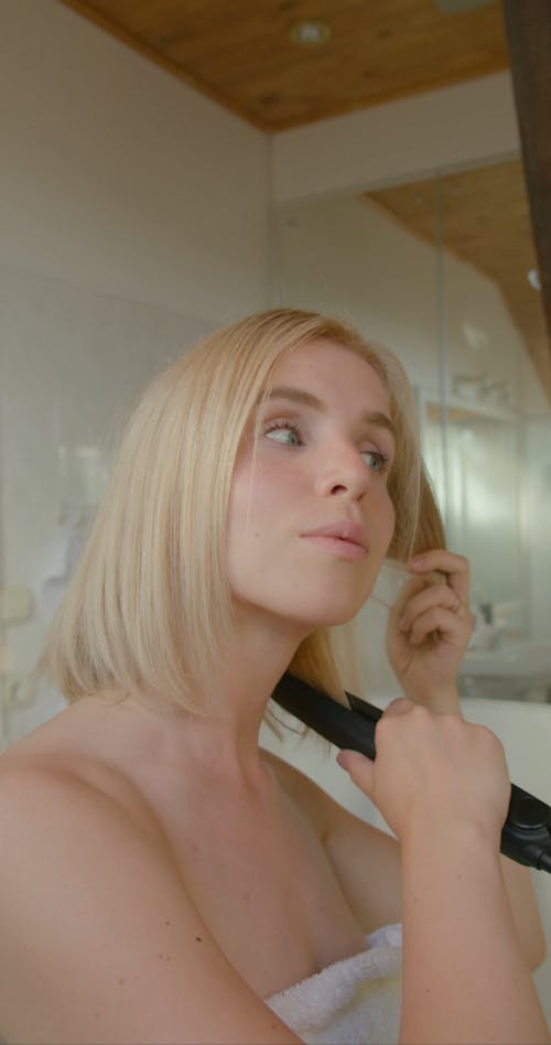 A Woman Straightening Her Hair