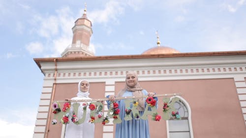 Women Smiling while Wearing Hijab Outside the Mosque