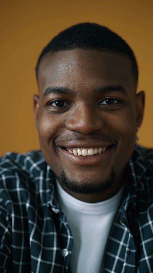 A Man Smiling at the Camera
