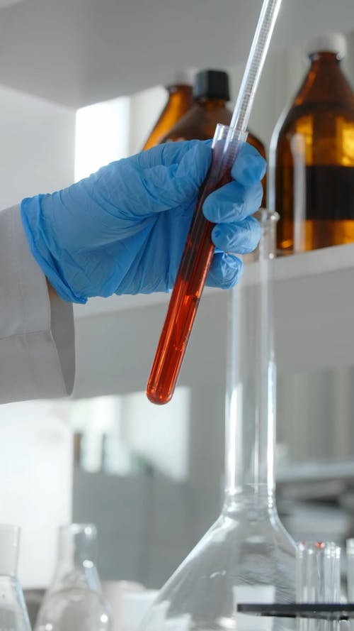 Close up of a Scientist Holding a Test Tube in a Lab