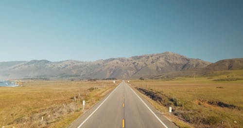 Drone Footage of a Road Leading to a Mountain