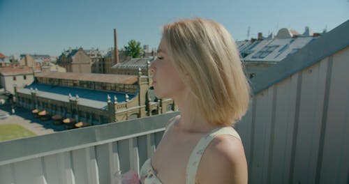 A Woman Drinking a Shake in an Outdoor Area