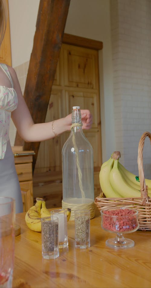 A Woman Pouring Milk in the Blender