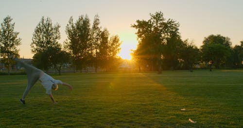 A Man Doing Backflips at a Park