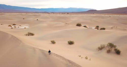 Woman Standing on Dune