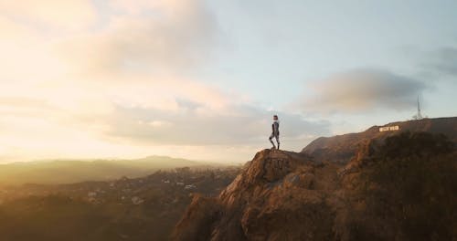 Woman Standing on a Cliff