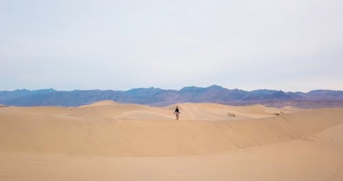 Woman Running on Dunes