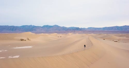 Woman Walking on Dunes