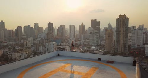 Woman Walking On the Edge of a Building