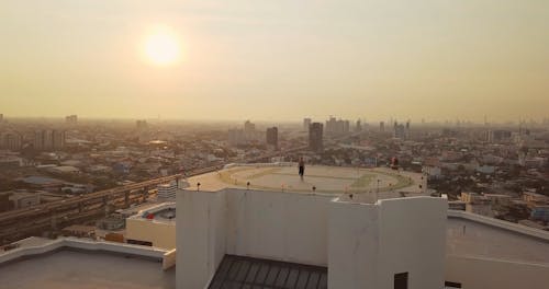 Aerial Footage of a Woman Walking on a Helipad