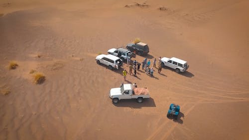 People with Their SUV in a Desert