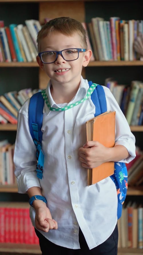 A Young Boy Posing in a Library