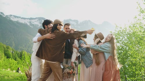 People Doing a Group Hug with the Bride and Groom