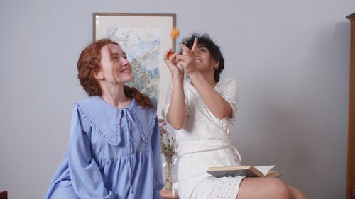 A Woman Juggling Peaches