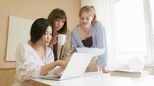 Women Using and Looking at a Laptop
