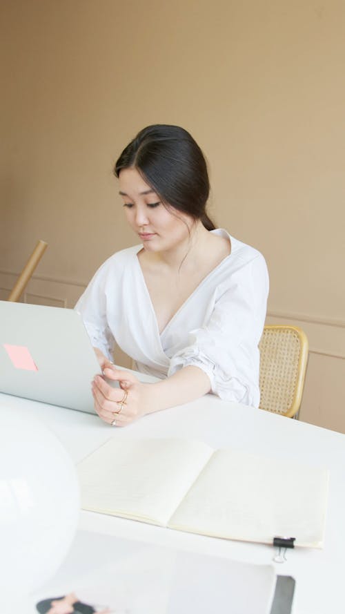 A Female Using a Laptop on a Table