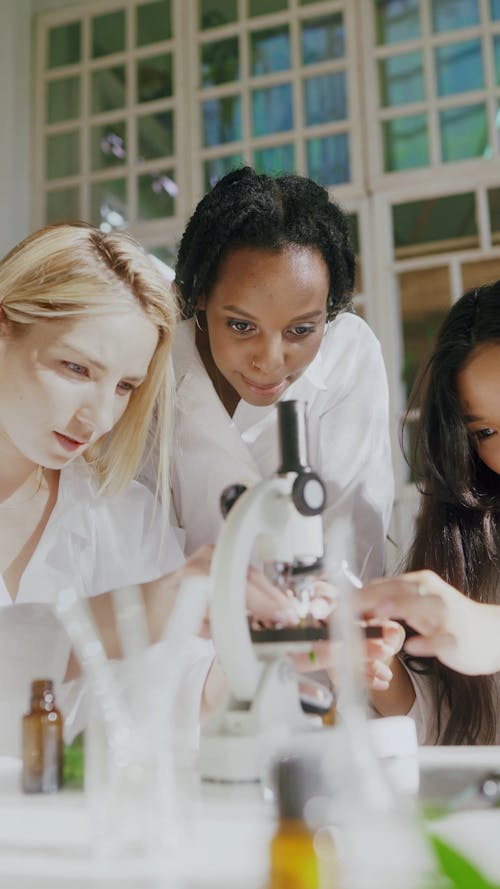 A Female Scientist using a Microscope
