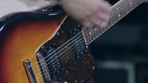 Close-up Video of a Person Playing Guitar