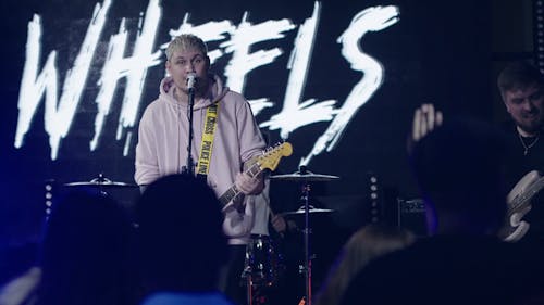 Man Singing while Playing Guitar