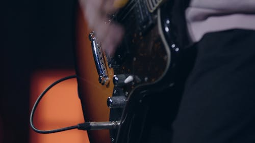 A Close Up of a Guitarist Playing an Electric Guitar
