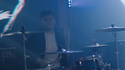 A Man Playing the Drum Set