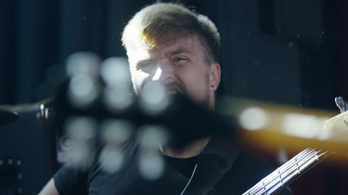 Medium Close Up of Man Playing a Bass Guitar
