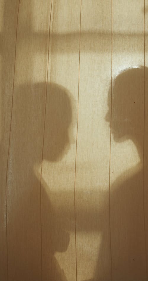 Shadow of Two People Touching Foreheads 