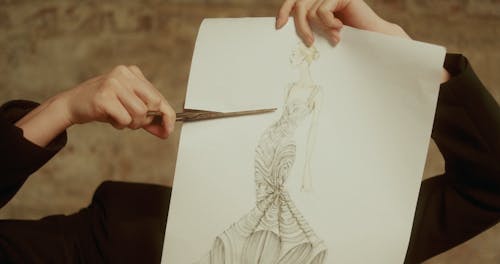 A Woman Cutting Paper with a Sketch