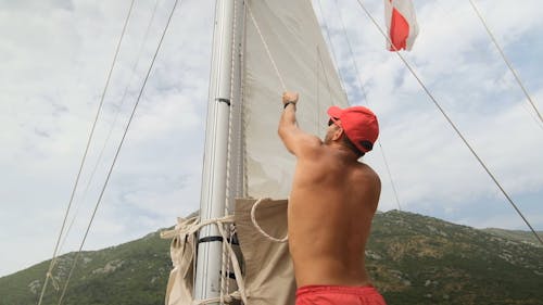 A Man Raising a Sailcloth