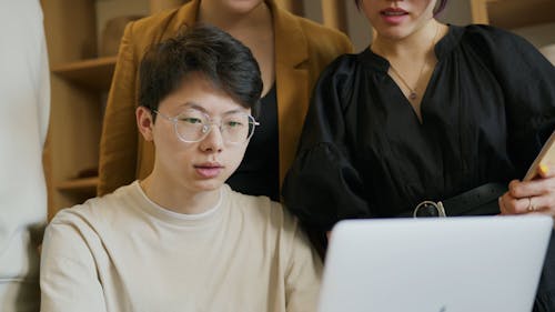 Man Wearing Eyeglasses Using a Laptop