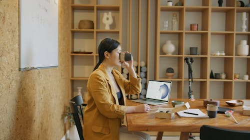 A Woman Drinking Coffee in a Conference Room