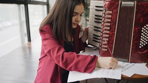 A Girl Writing Musical Notes