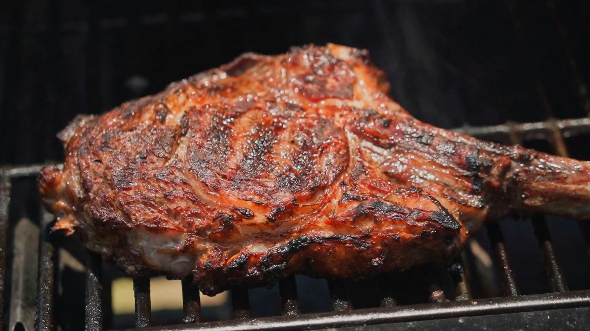 A Close up of a Tomahawk Steak on a Barbecue Grill · Free Stock Video