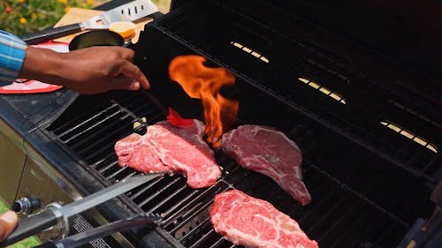  Close Up of a Person Grilling a Steak