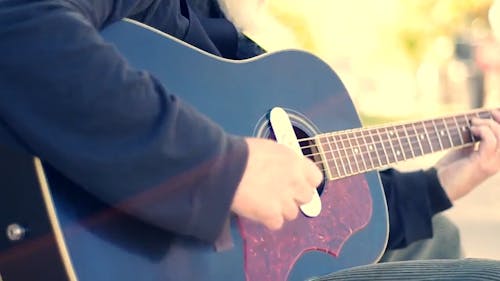 Street Artist Singing and Playing Guitar