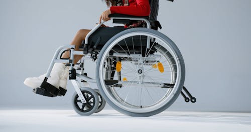 A Person Sitting on Wheelchair Spinning the Disco Ball