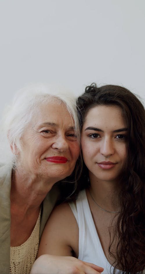 An Elderly Woman and a Young Woman Posing Together