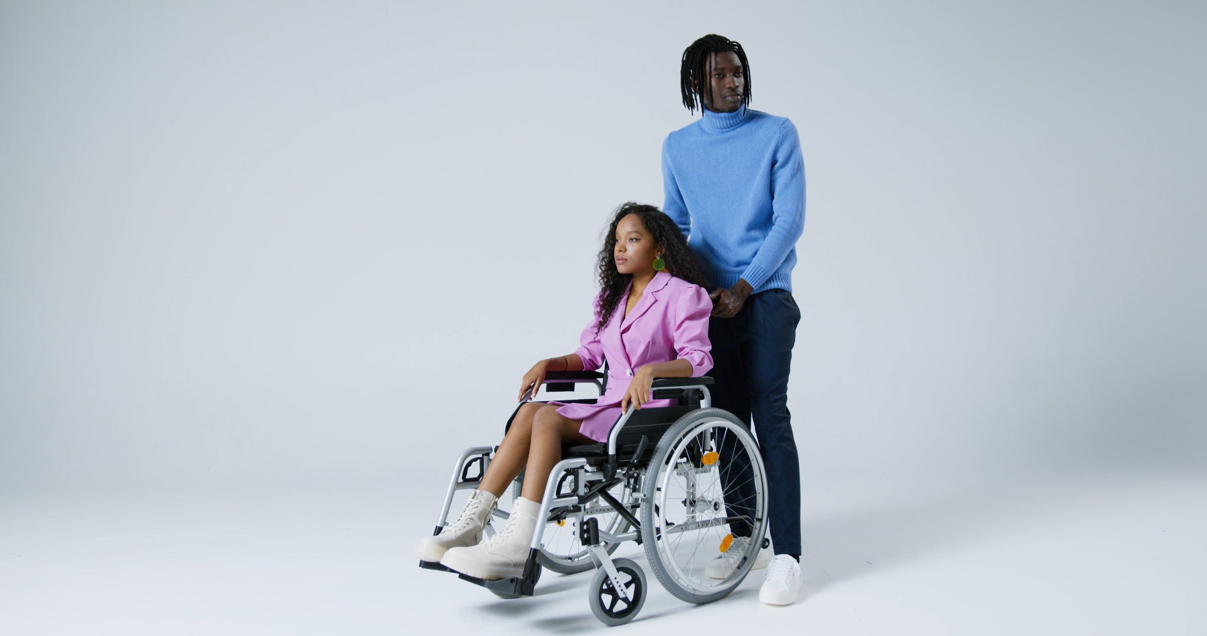 A Woman Sitting on Wheelchair while a Man Standing Behind Her · Free ...