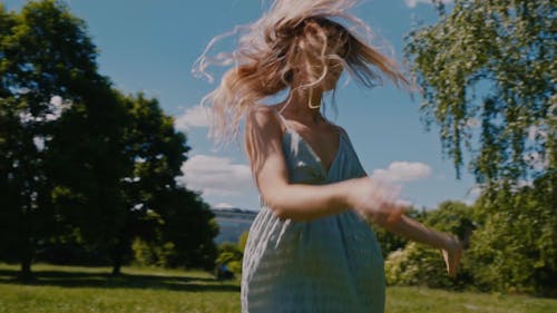 Arc Shot of a Woman Dancing and Flipping her Hair