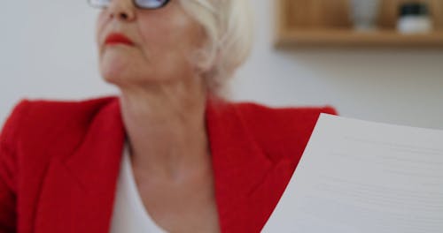 An Elderly Woman Reading Documents
