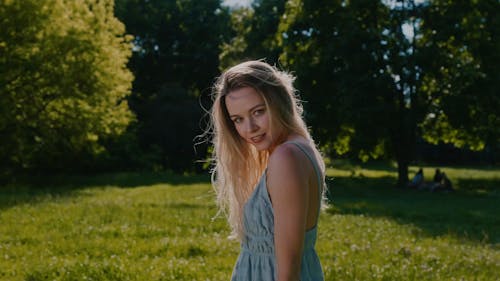 A Woman Flipping her Hair on a Windy Day at the Park