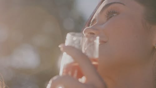 A Beautiful Woman Drinking an Alcoholic Beverage