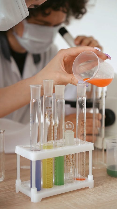 A Scientist Placing Powder into a Chemical in a Beaker Free Stock Video ...