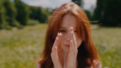 Close up of a Woman Fixing her Hair